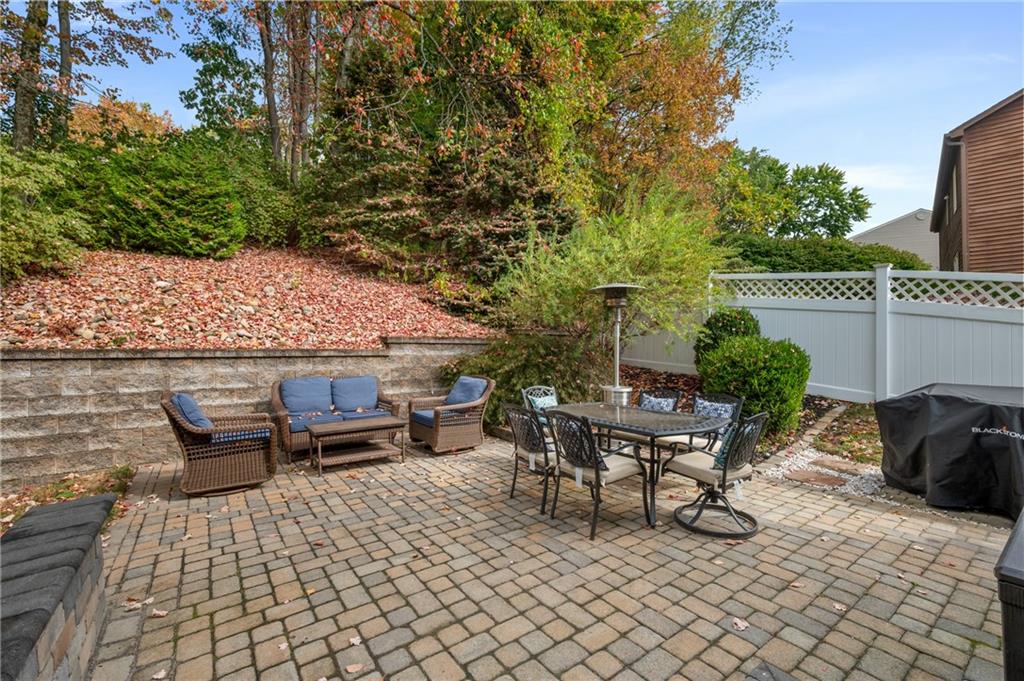 122 Rippling Brook Drive Sewickley, PA 15143 - Photo 26 of 31 a view of a patio with table and chairs and potted plants