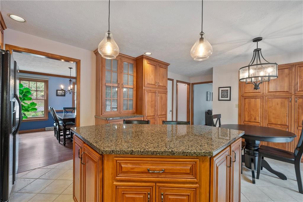 122 Rippling Brook Drive Sewickley, PA 15143 - Photo 8 of 31 a kitchen with granite countertop cabinets a dining table and chairs
