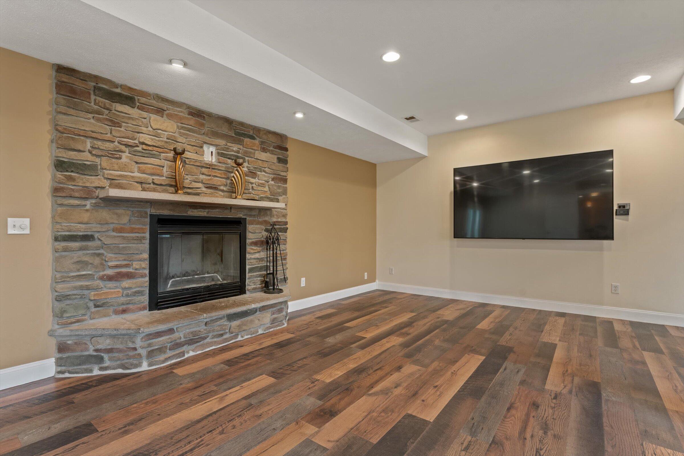 7692 North Emery Road Rolling Prairie, IN 46371 - Photo 12 of 69 a living room with a fireplace and a flat screen tv
