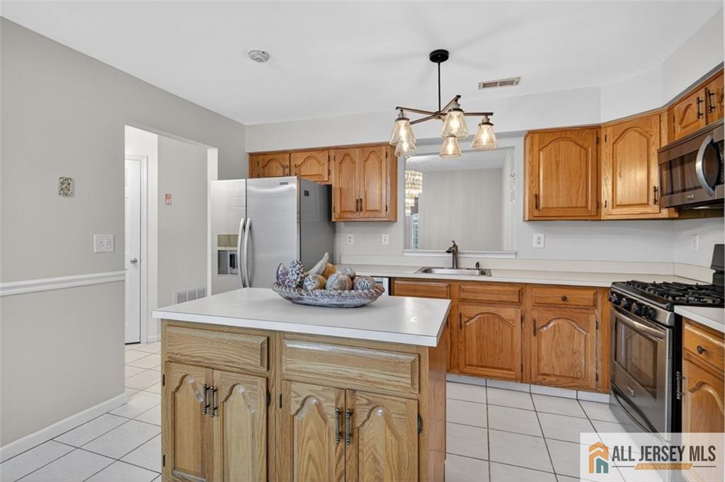 40C Rutland Lane, Unit 40B Monroe Township, NJ 08831 - Photo 11 of 37 a kitchen with stainless steel appliances granite countertop a sink stove and cabinets