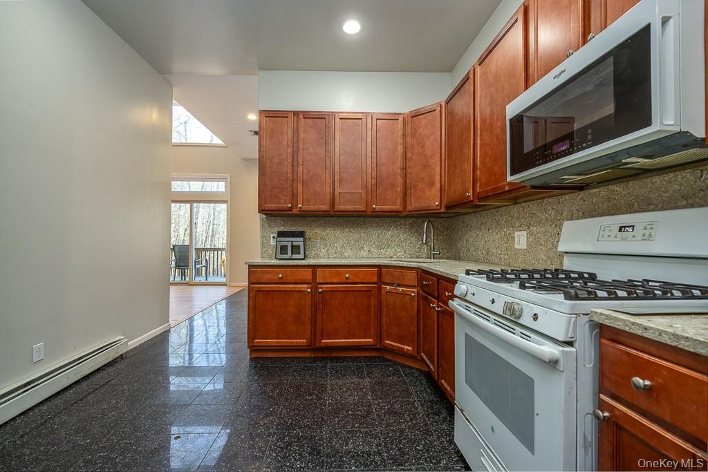 85 York Road Bloomingburg, NY 12721 - Photo 15 of 32 a kitchen with stainless steel appliances granite countertop wooden cabinets a stove top oven a sink and dishwasher