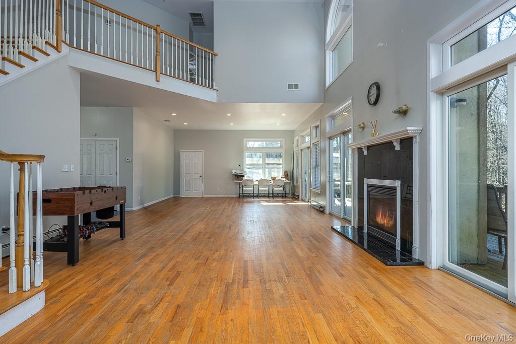 85 York Road Bloomingburg, NY 12721 - Photo 18 of 32 a big room with wooden floor fireplace and windows