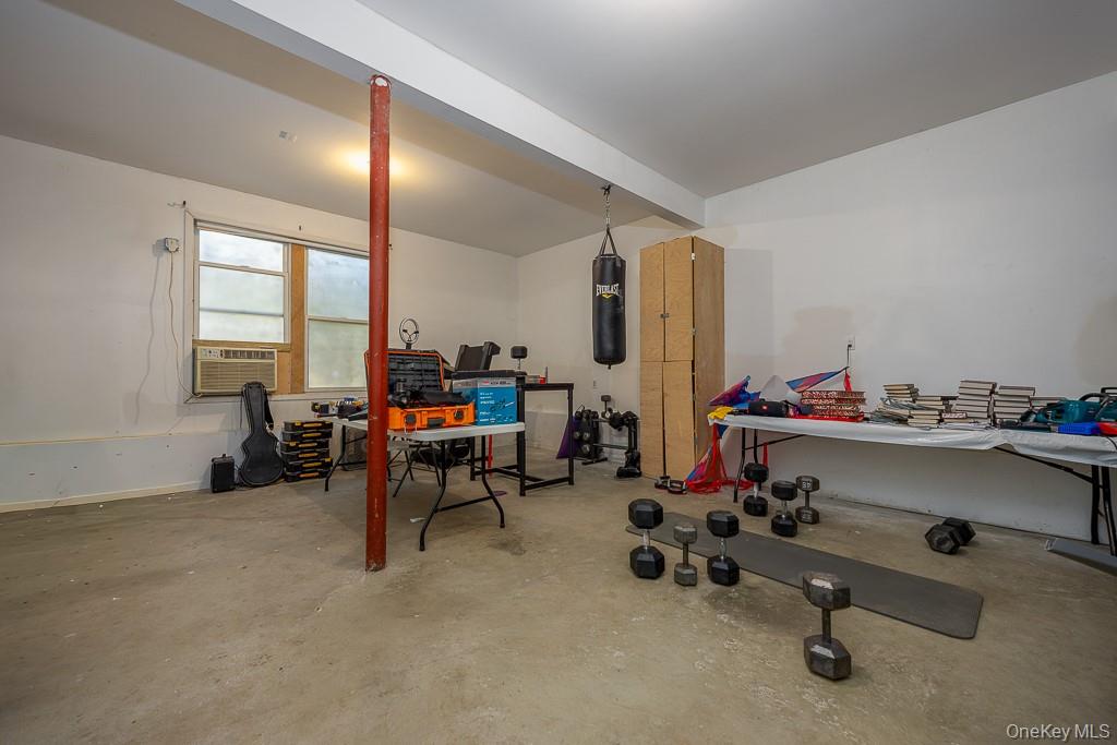85 York Road Bloomingburg, NY 12721 - Photo 23 of 32 a living room with furniture gym equipment and a large window