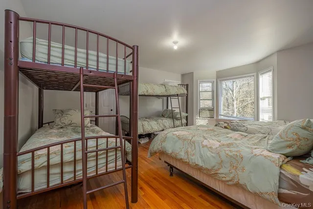 a bedroom with a bed and a large window