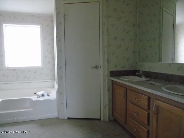 2480 East View Ridge Road Rimrock, AZ 86335 - Photo 11 of 20 a bathroom with a granite countertop sink and a bathtub