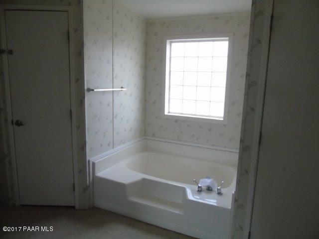 2480 East View Ridge Road Rimrock, AZ 86335 - Photo 12 of 20 a bath tub sitting next to a window
