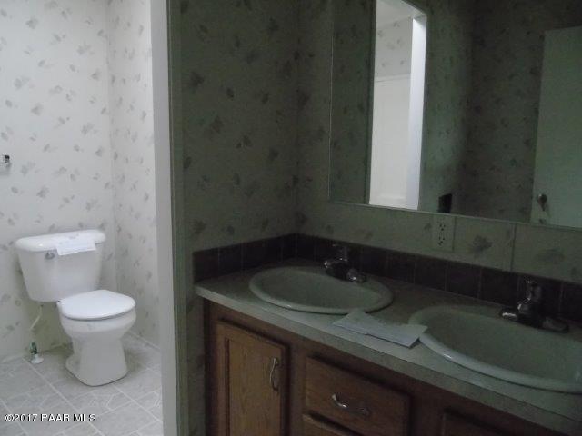 2480 East View Ridge Road Rimrock, AZ 86335 - Photo 15 of 20 a bathroom with a sink a toilet and a mirror
