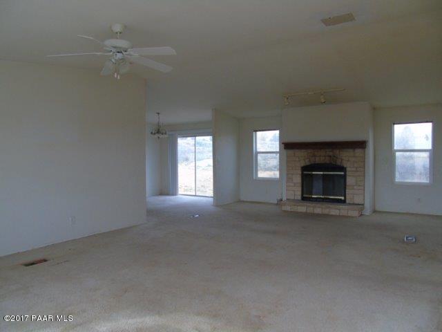 2480 East View Ridge Road Rimrock, AZ 86335 - Photo 4 of 20 an empty room with windows and fireplace