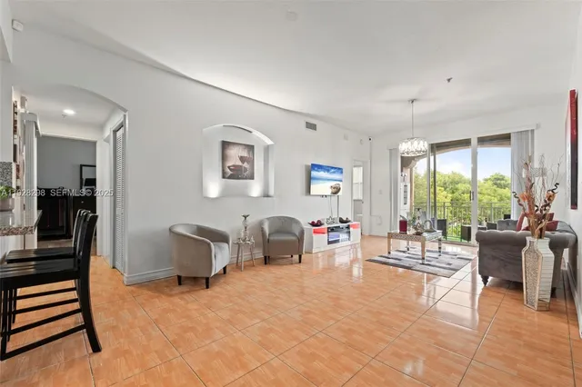 a living room with furniture and a large window