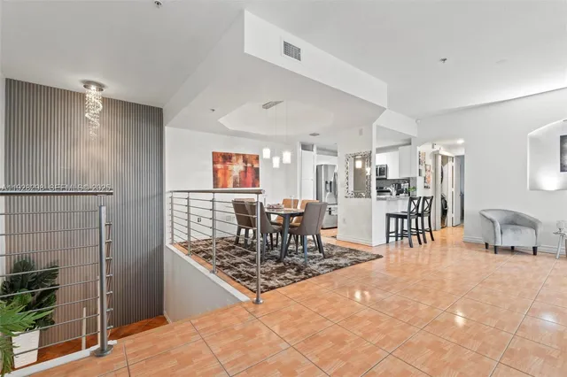 a kitchen with stainless steel appliances kitchen island granite countertop a refrigerator and a wooden cabinets
