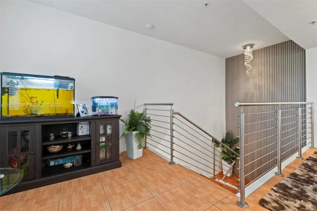 a view of a livingroom with furniture and staircase
