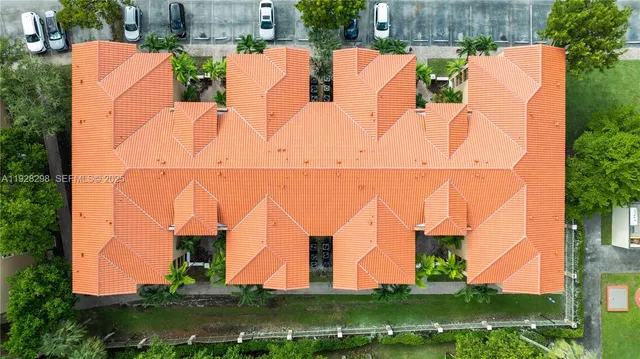aerial view of a house with yard and green space