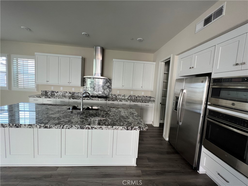 110 Sculpture Irvine, CA 92618 - Photo 11 of 37 a kitchen with stainless steel appliances granite countertop a sink stove and refrigerator