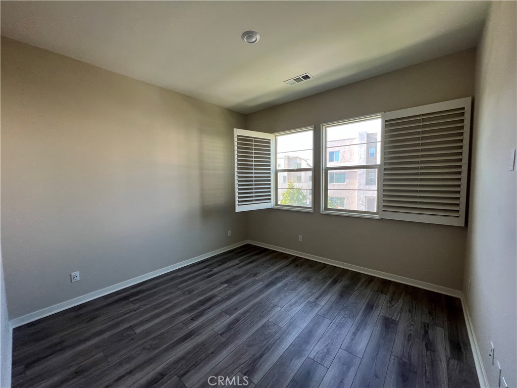 110 Sculpture Irvine, CA 92618 - Photo 14 of 37 a view of an empty room with wooden floor and a window