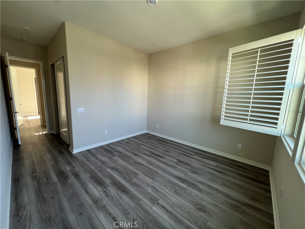 110 Sculpture Irvine, CA 92618 - Photo 15 of 37 a view of an empty room with wooden floor and a window