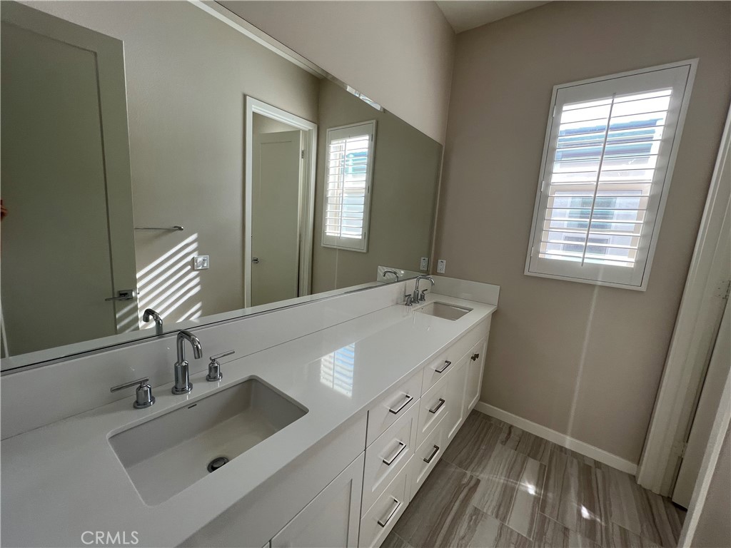110 Sculpture Irvine, CA 92618 - Photo 16 of 37 a bathroom with a sink and a mirror