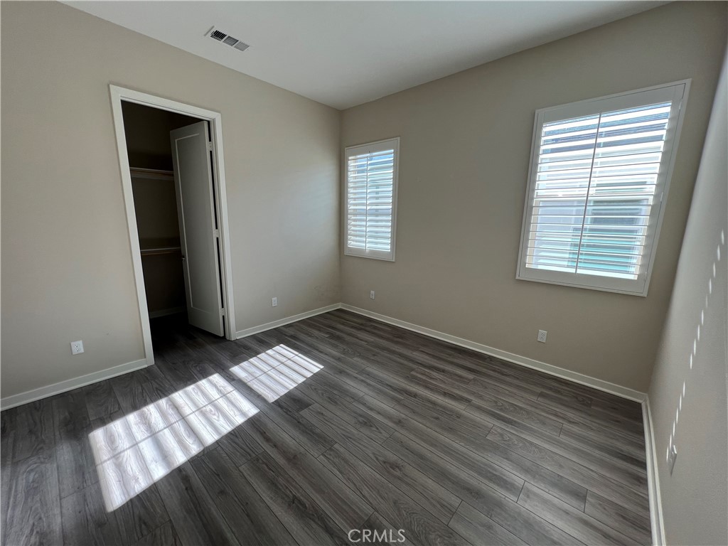 110 Sculpture Irvine, CA 92618 - Photo 17 of 37 an empty room with wooden floor and windows