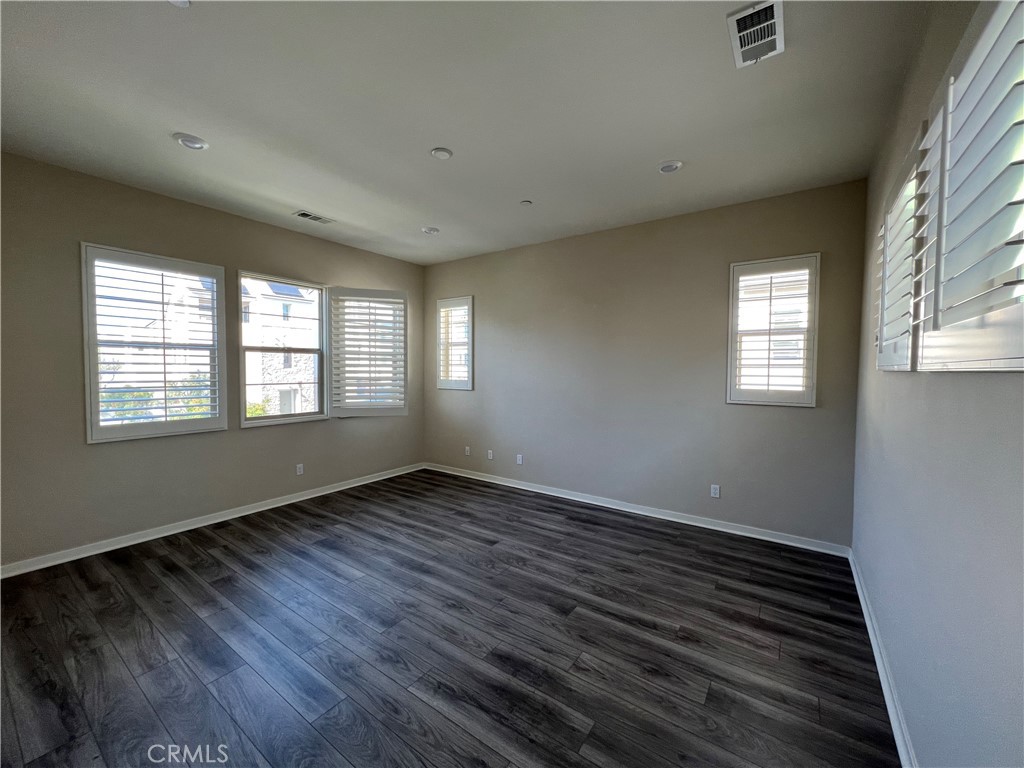 110 Sculpture Irvine, CA 92618 - Photo 18 of 37 a view of an empty room with wooden floor and a window