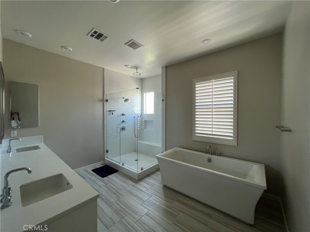 110 Sculpture Irvine, CA 92618 - Photo 20 of 37 a bathroom with a tub sink vanity granite and shower