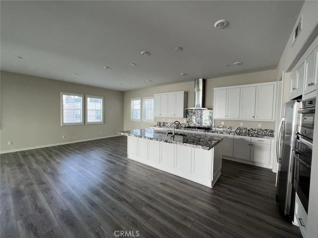 110 Sculpture Irvine, CA 92618 - Photo 2 of 37 a kitchen with stainless steel appliances granite countertop a white cabinets and wooden floors