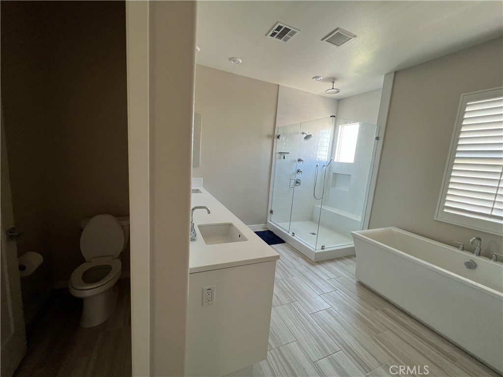 110 Sculpture Irvine, CA 92618 - Photo 21 of 37 a bathroom with a tub shower sink vanity and a toilet