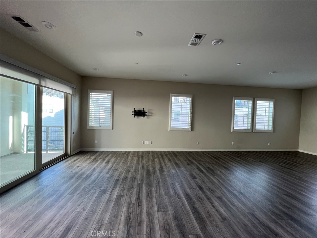 110 Sculpture Irvine, CA 92618 - Photo 24 of 37 an empty room with wooden floor and windows