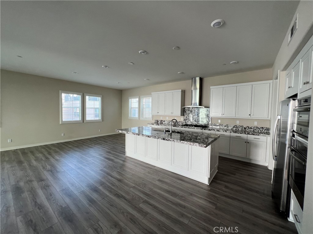 110 Sculpture Irvine, CA 92618 - Photo 4 of 37 a kitchen with stainless steel appliances granite countertop a stove a sink and a refrigerator