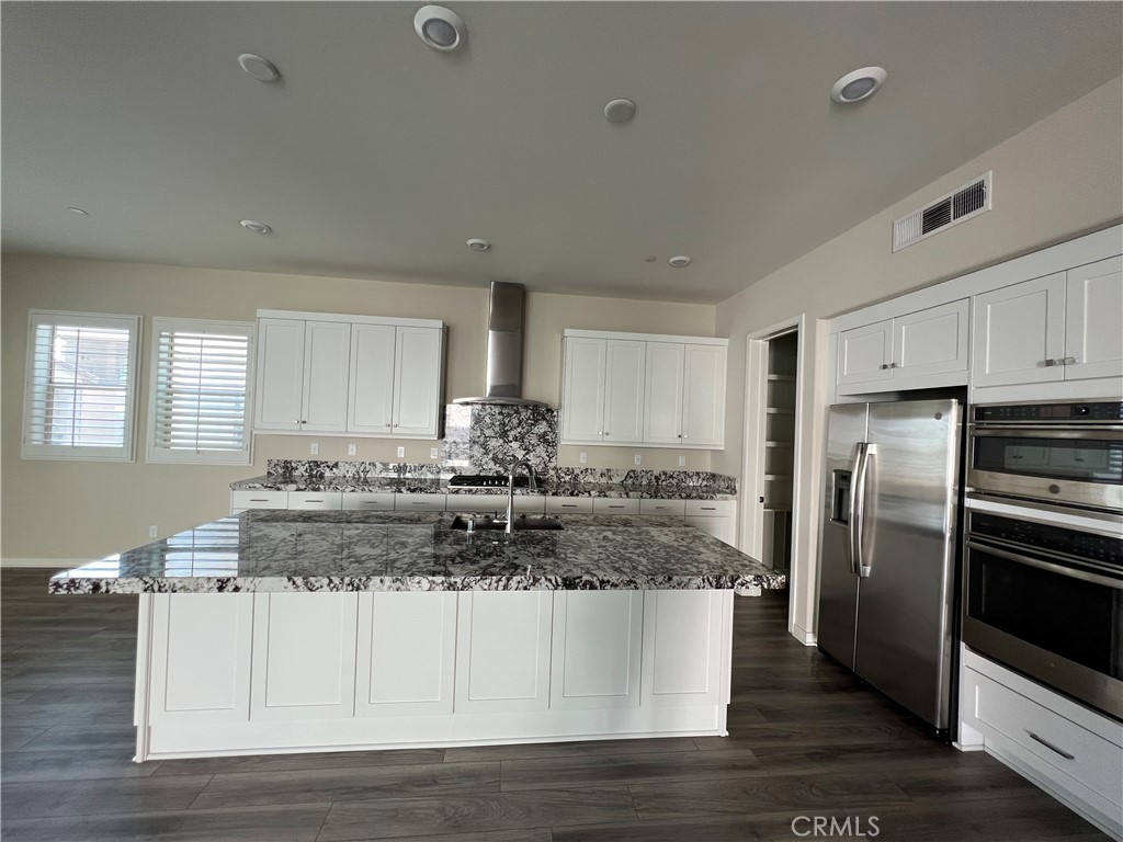 110 Sculpture Irvine, CA 92618 - Photo 7 of 37 a kitchen with stainless steel appliances granite countertop a stove a sink and a refrigerator