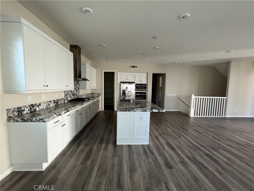 110 Sculpture Irvine, CA 92618 - Photo 8 of 37 a large kitchen with a wooden floor and stainless steel appliances
