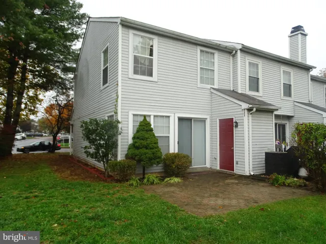 a front view of a house with a garden and plants