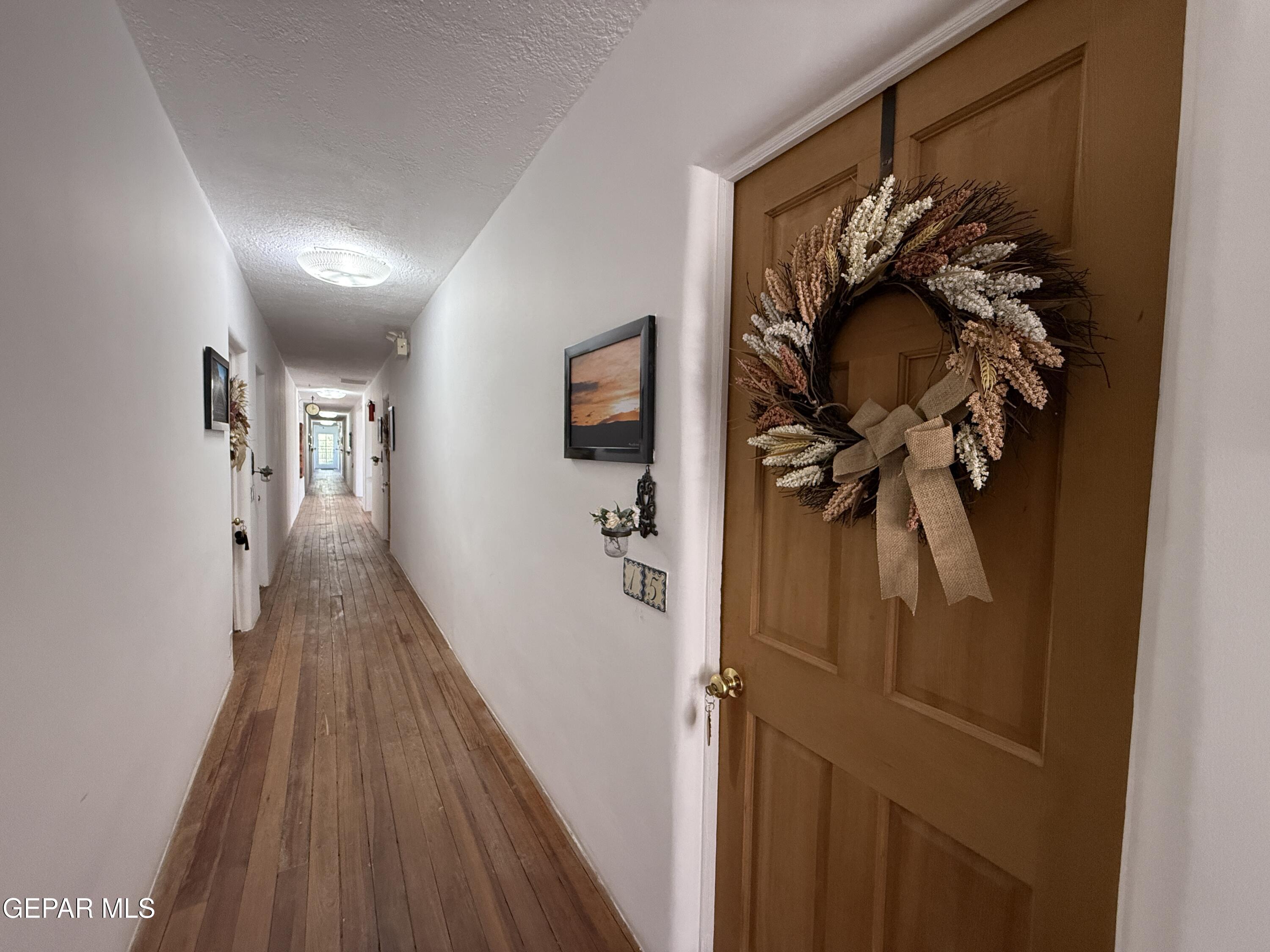 2200 County Rd D061 Las Cruces, NM 88007 - Photo 21 of 38 a view of a hallway with wooden floor and stairs