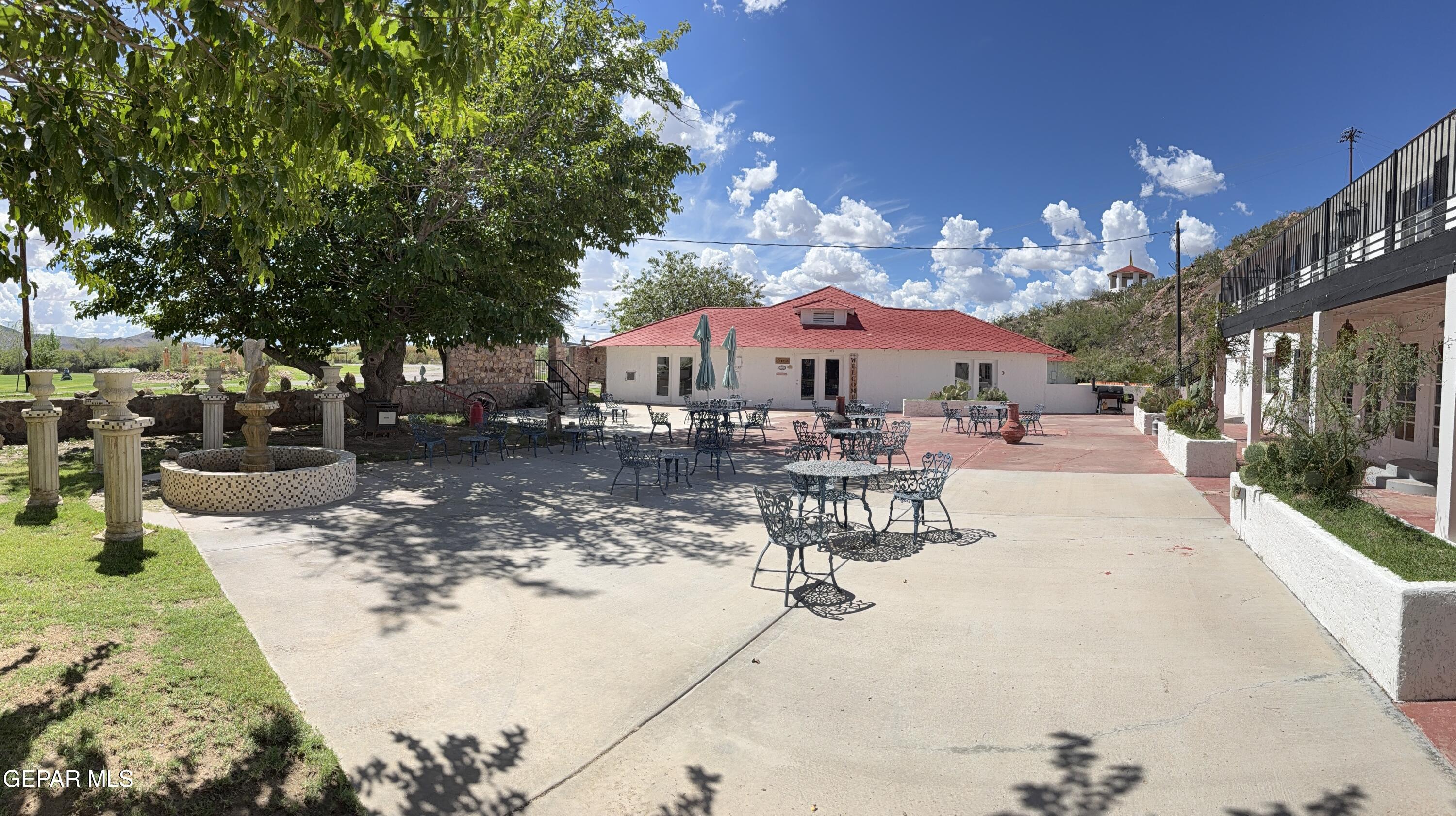 2200 County Rd D061 Las Cruces, NM 88007 - Photo 27 of 38 a view of a patio with a table and chairs under an umbrella