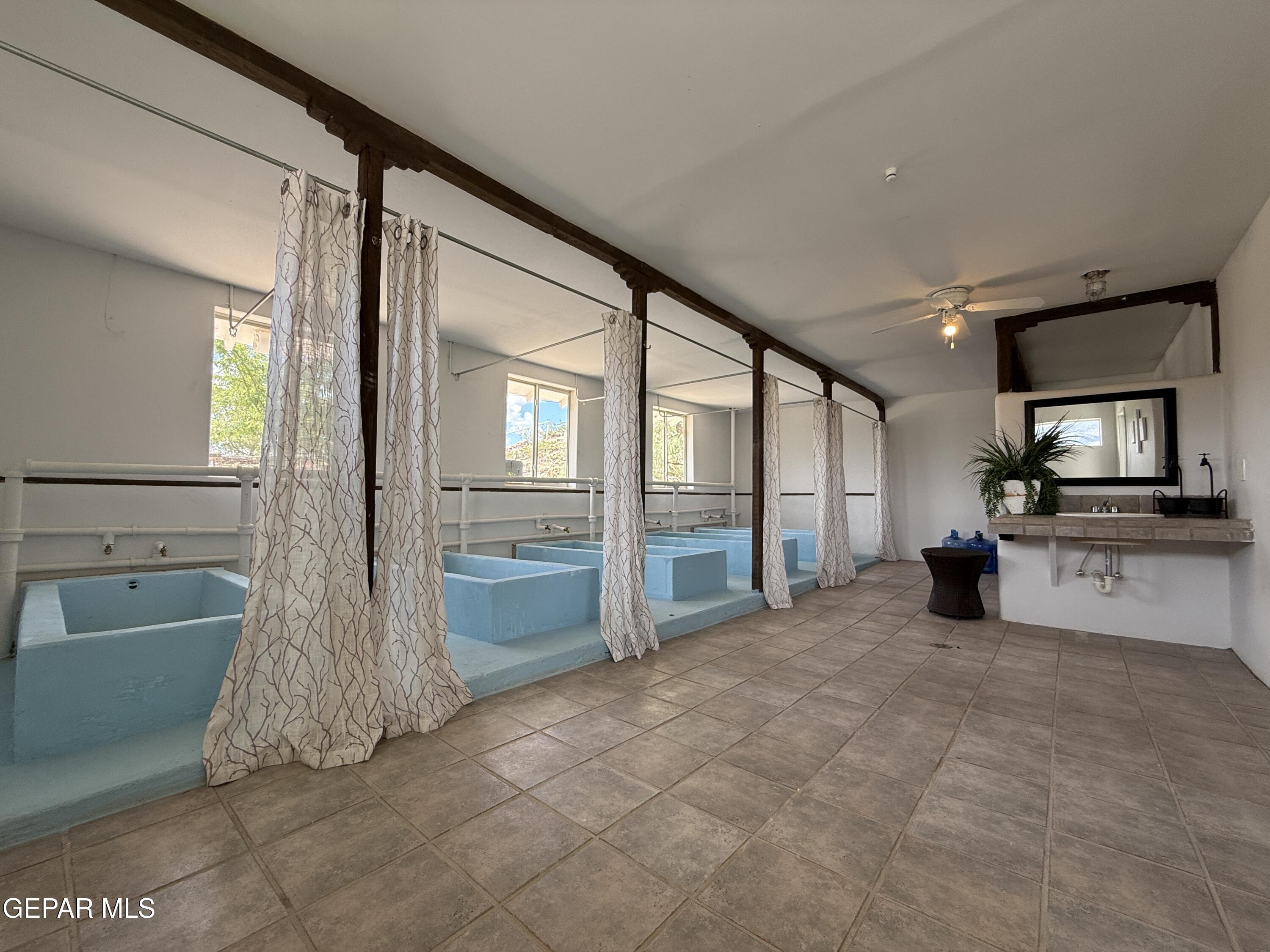 2200 County Rd D061 Las Cruces, NM 88007 - Photo 29 of 38 a view of a big room with windows and chandelier