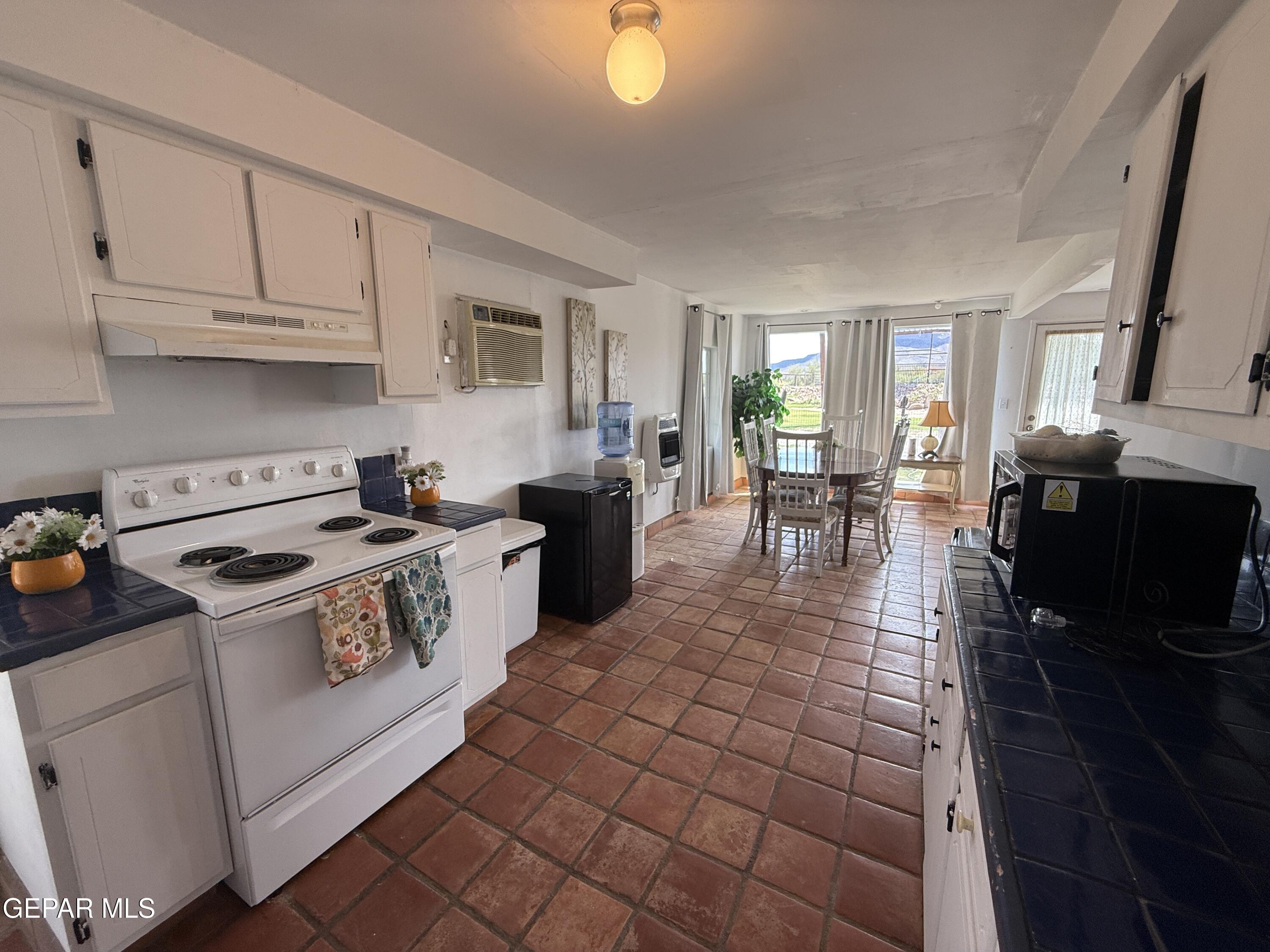 2200 County Rd D061 Las Cruces, NM 88007 - Photo 35 of 38 a kitchen with a stove a sink and a microwave