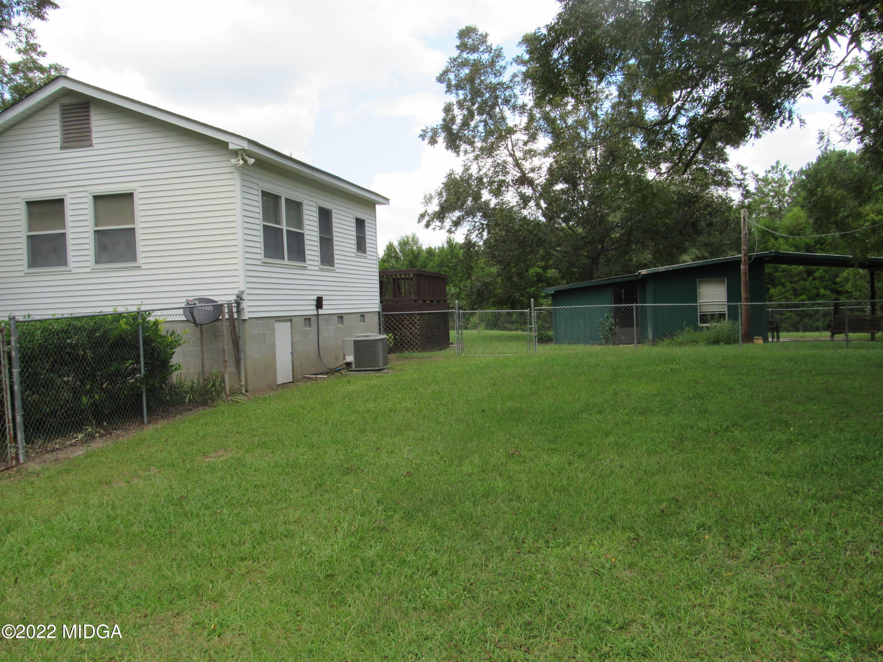6999 South Rogers Road Macon, GA 31216 - Photo 11 of 61 a backyard of a house with wooden floor and fence