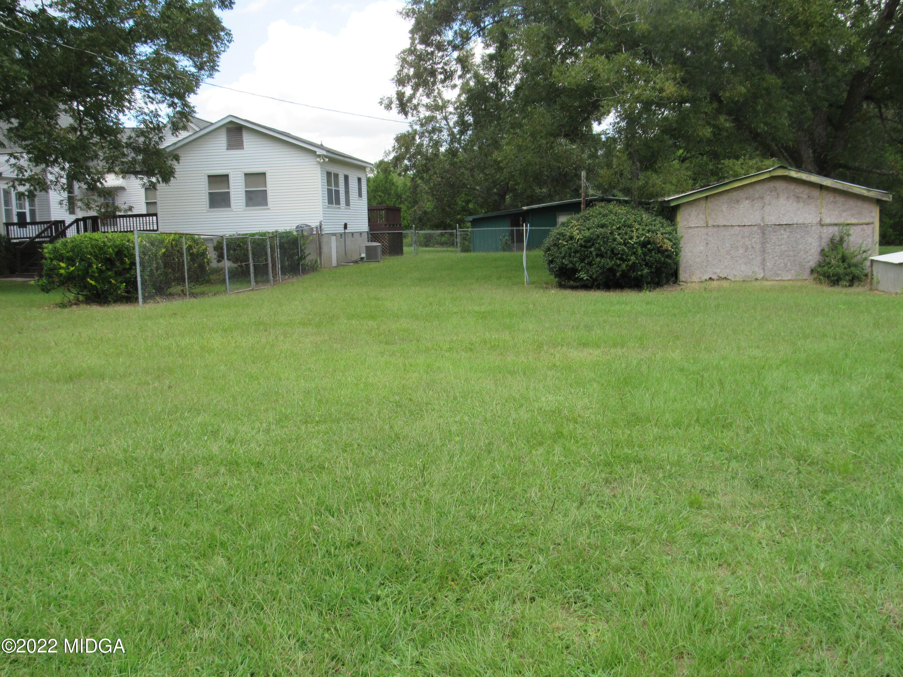 6999 South Rogers Road Macon, GA 31216 - Photo 14 of 61 a view of a house with backyard and a garden