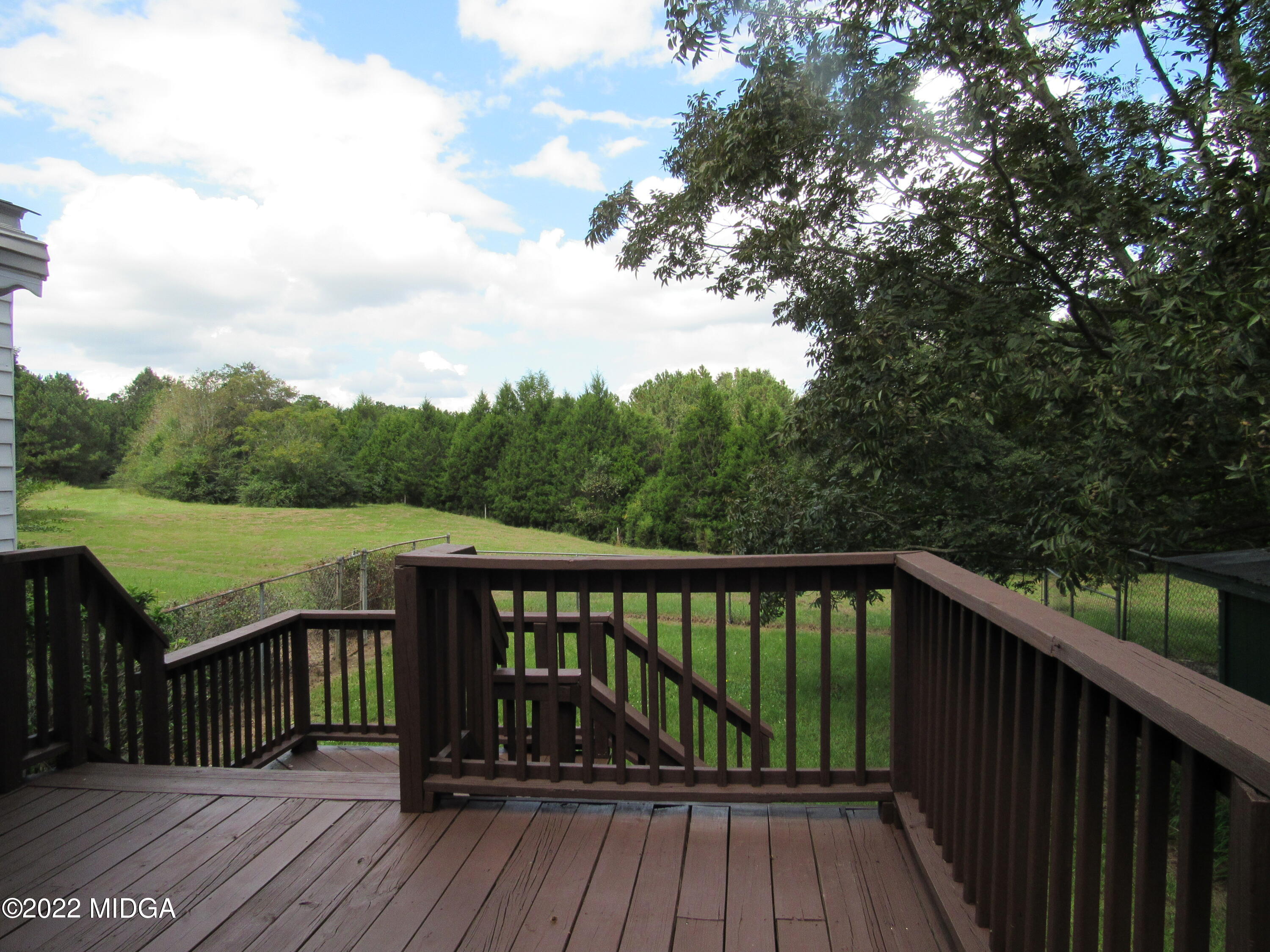 6999 South Rogers Road Macon, GA 31216 - Photo 19 of 61 a balcony with wooden floor and outdoor seating