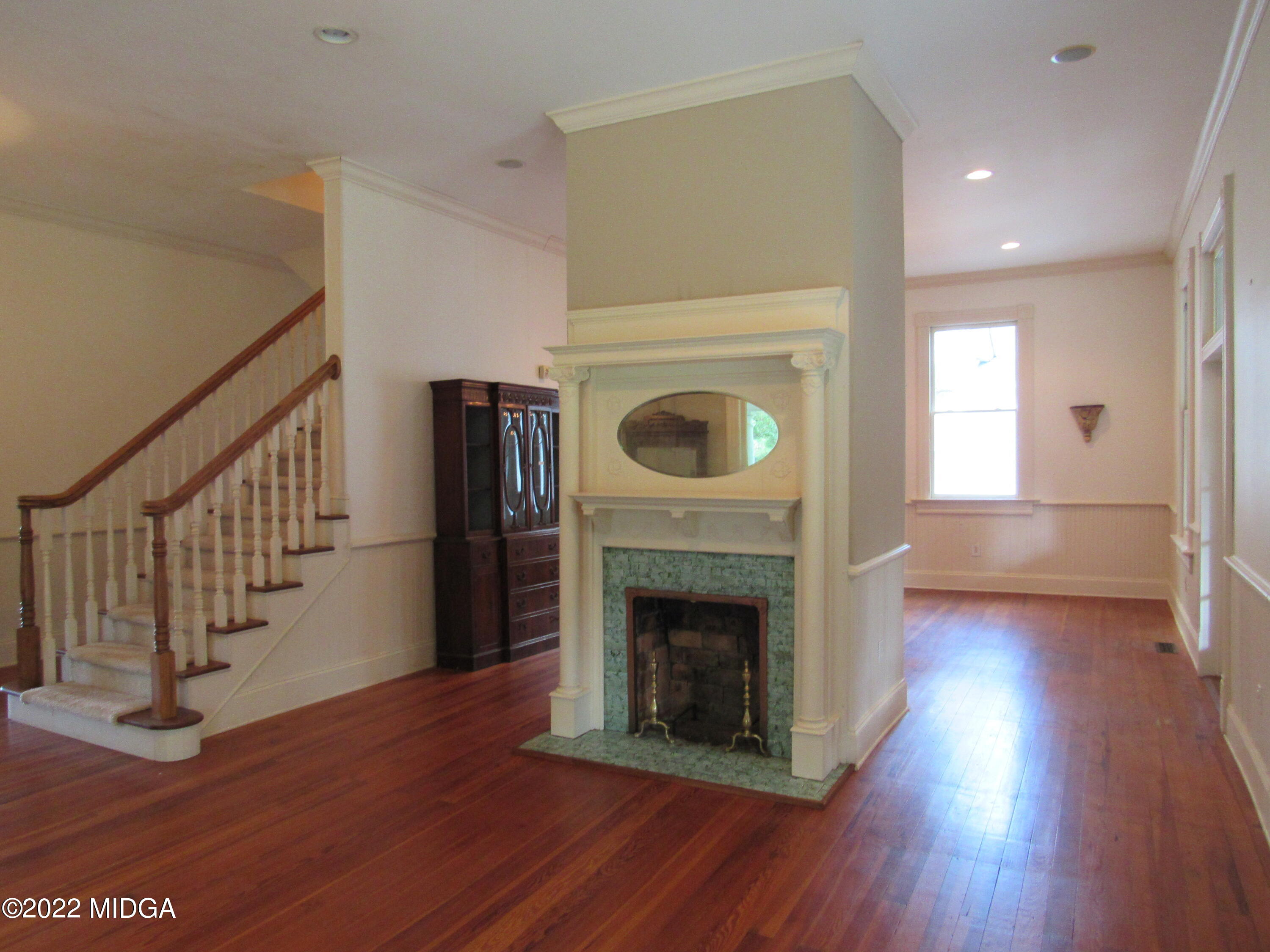 6999 South Rogers Road Macon, GA 31216 - Photo 29 of 61 a view of an empty room with wooden floor fireplace and a window