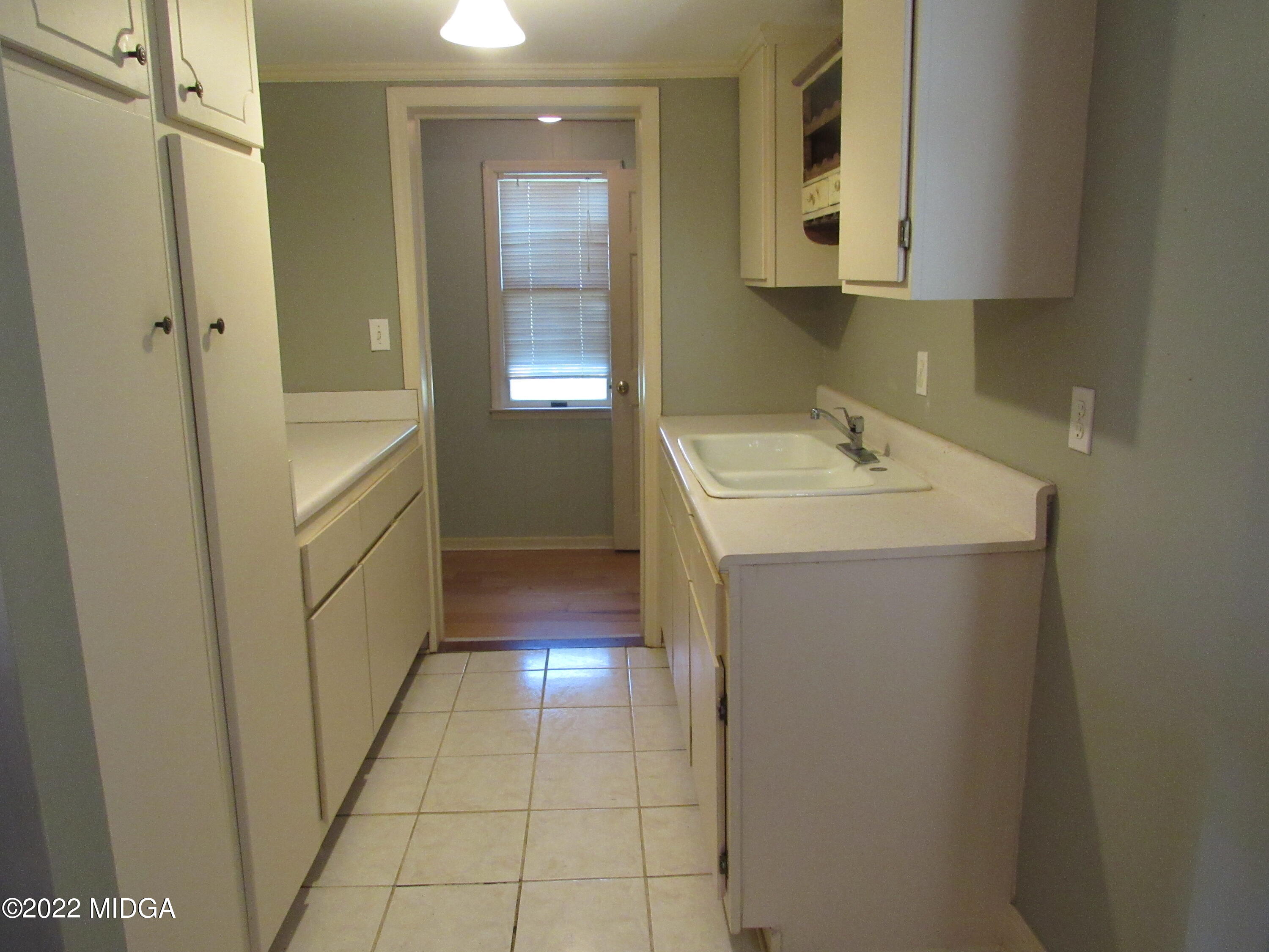 6999 South Rogers Road Macon, GA 31216 - Photo 38 of 61 a bathroom with a sink a toilet and a mirror