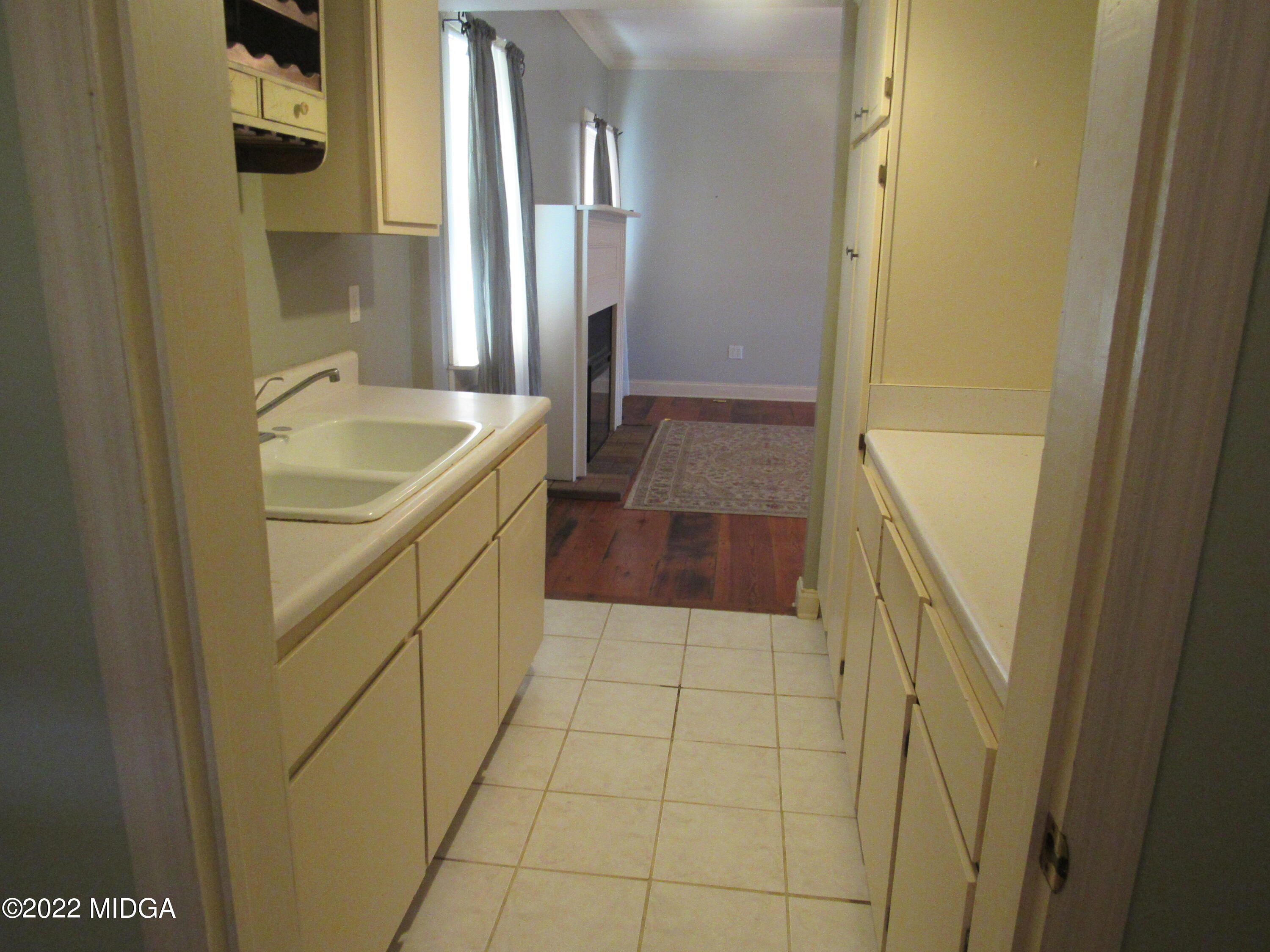 6999 South Rogers Road Macon, GA 31216 - Photo 39 of 61 a bathroom with a granite countertop sink a toilet and shower