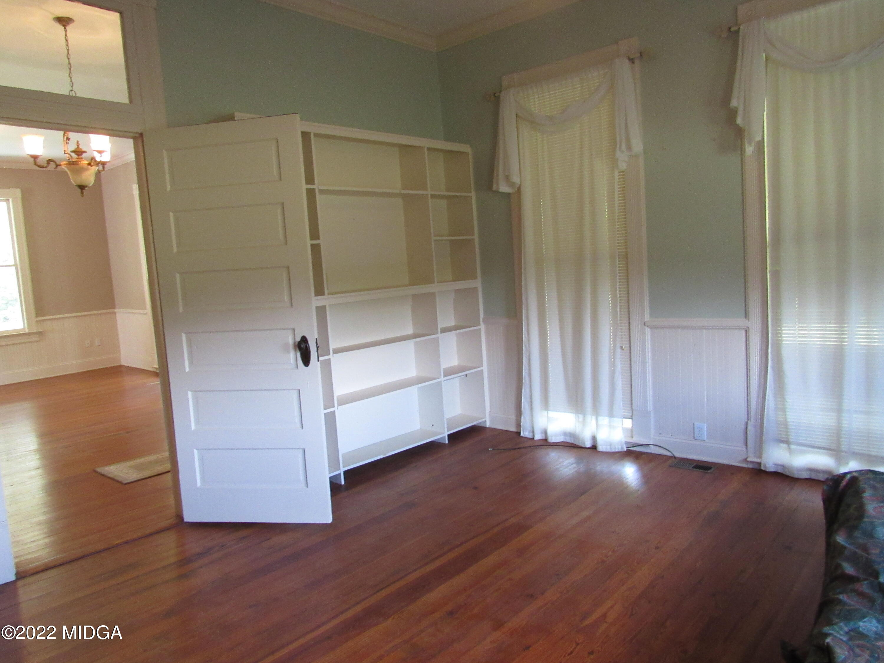 6999 South Rogers Road Macon, GA 31216 - Photo 45 of 61 a view of an empty room with wooden floor and a window