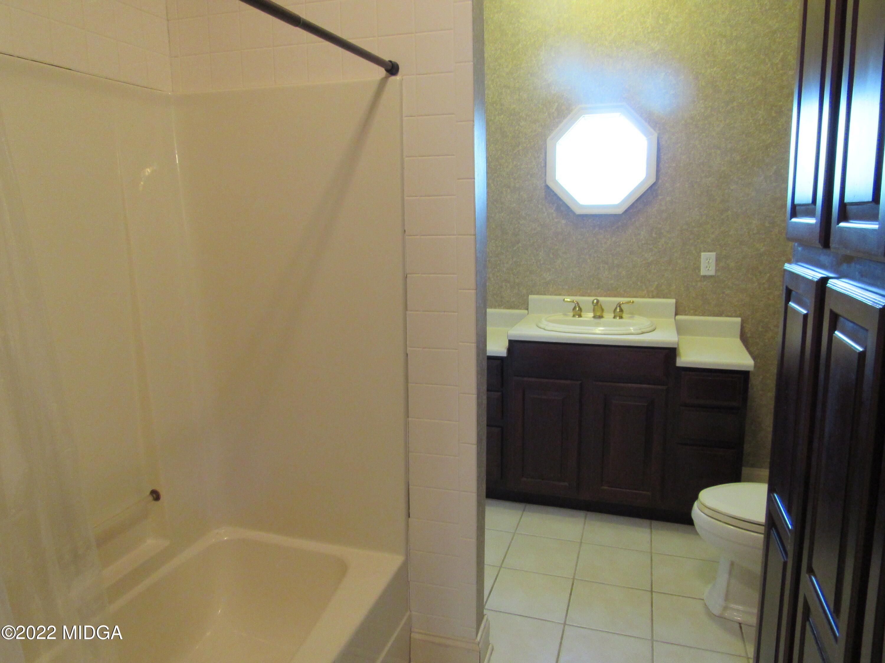 6999 South Rogers Road Macon, GA 31216 - Photo 50 of 61 a bathroom with a sink a toilet and shower