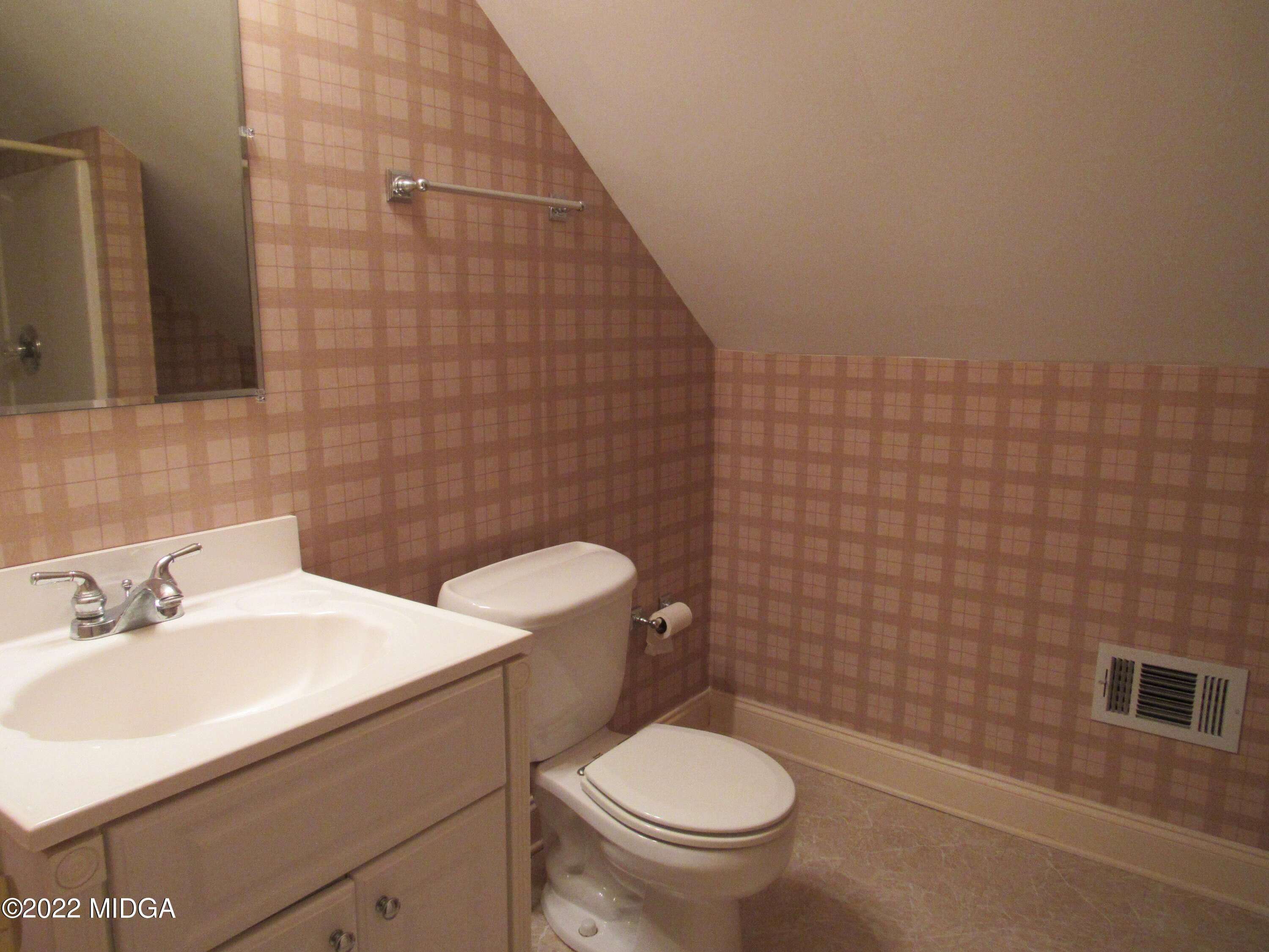 6999 South Rogers Road Macon, GA 31216 - Photo 56 of 61 a bathroom with a sink a toilet and a mirror