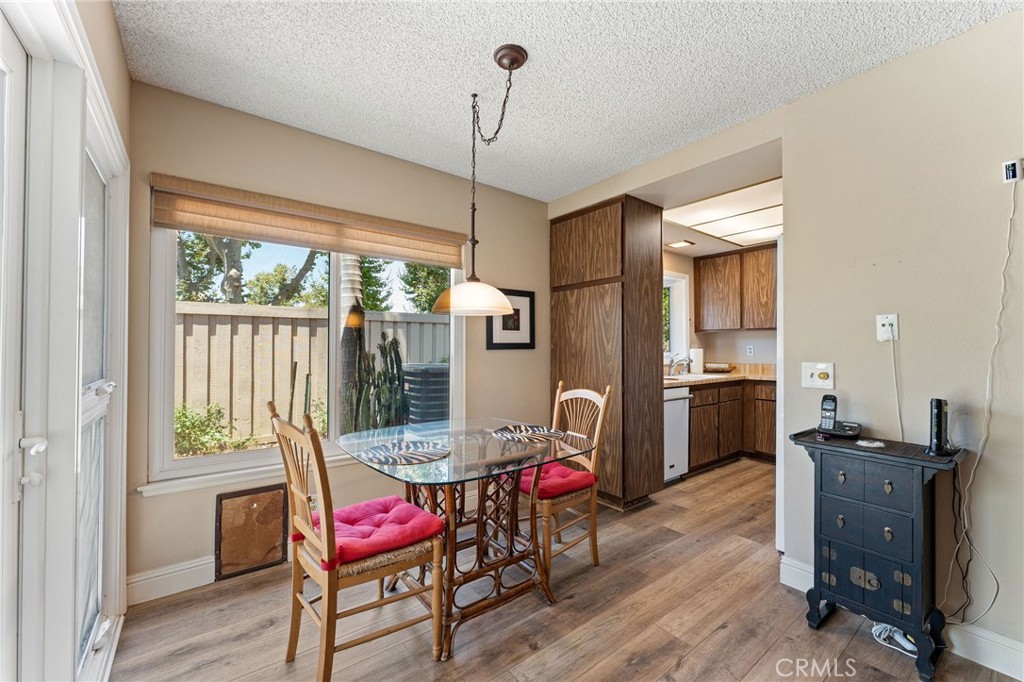 92 Orchard Irvine, CA 92618 - Photo 12 of 46 a view of a dining room with furniture window and wooden floor