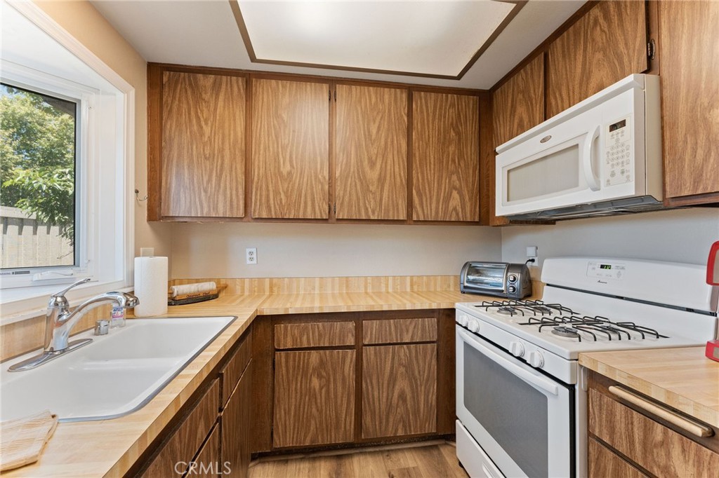 92 Orchard Irvine, CA 92618 - Photo 16 of 46 a kitchen with a sink stove and cabinets