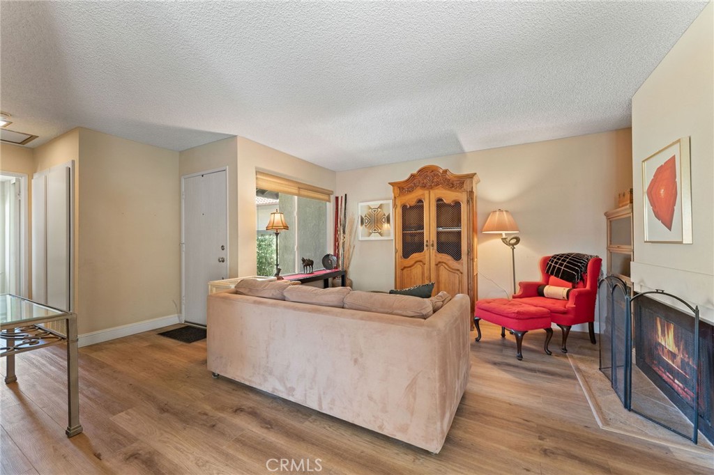92 Orchard Irvine, CA 92618 - Photo 5 of 46 a living room with furniture a wooden floor and a large window
