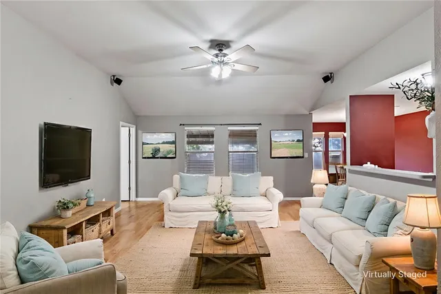 a living room with furniture and a flat screen tv