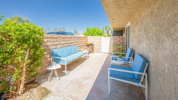 a view of a patio with a table and chairs