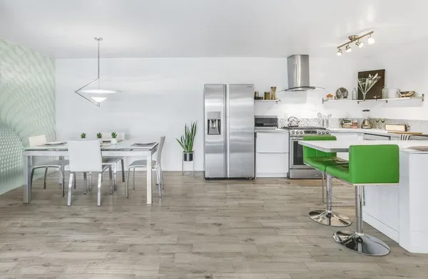 a kitchen with kitchen island a dining table and chairs