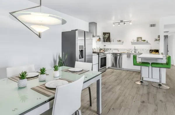 a kitchen with stainless steel appliances granite countertop a white cabinets and a stove